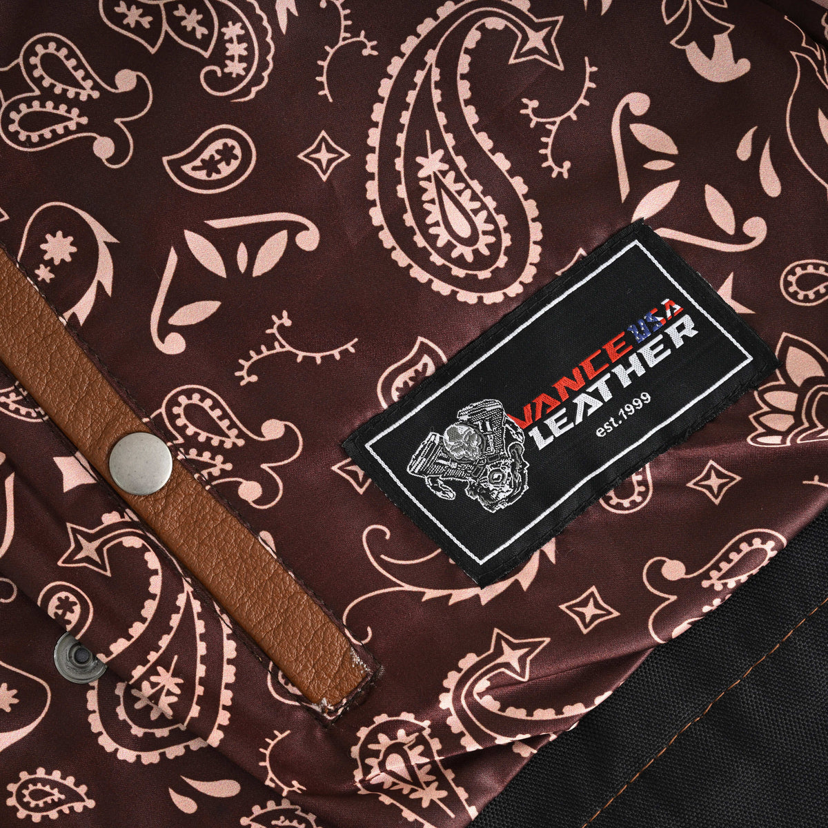 Vance Leathers label beside a leather-trimmed interior CCW pocket snap on the motorcycle vest's brown paisley lining.