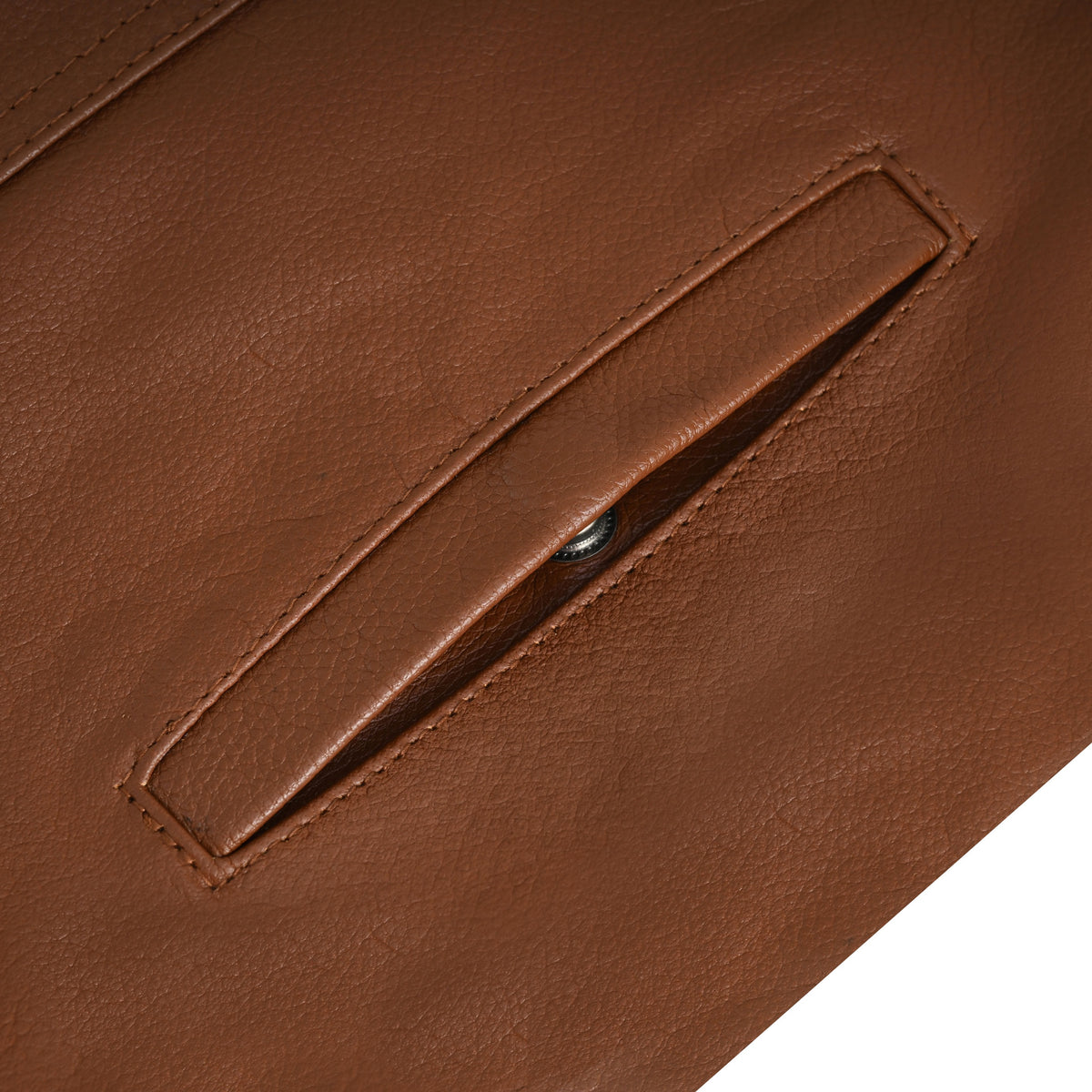 Close-up of the cognac leather motorcycle vest's welt hand-warmer pocket, showing edge stitching and a metal snap inside.