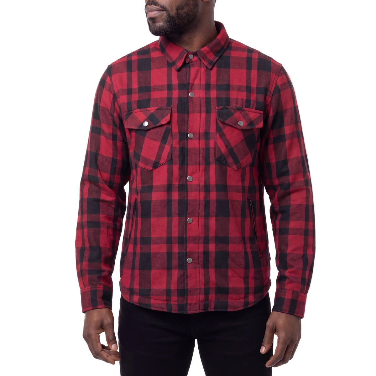 Model wearing a red and black plaid men’s armored motorcycle flannel shirt with snap-front closure and chest pockets.