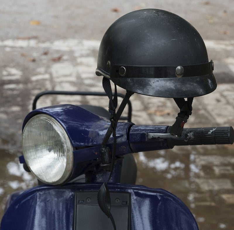 Close up of a motor scooter and a half helmet